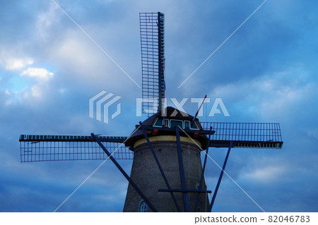 A peaceful view along the canal of the windmills at Kinderdijk in the Netherlands A peaceful view along the canal of the windmills at Kinderdijk in the Netherlands 82046783