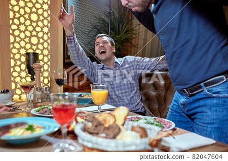 two men in a restaurant arguing during lunch two men in a restaurant arguing during lunch 82047604