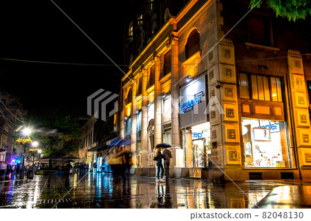 BELGRADE, SERBIA - SEPTEMBER 25: Rainy night at Knez Mihailova Street on September 25, 2015 in Belgrade, Serbia. Street is the main shopping mile of Belgrade. BELGRADE, SERBIA - SEPTEMBER 25: Rainy night at Knez Mihailova Street on September 25, 2015 in Belgrade, Serbia. Street is the main shopping mile of Belgrade. 82048130