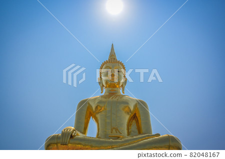 Golden buddha witn peaceful face under the sun at noon , calm and mindfulness concept 82048167