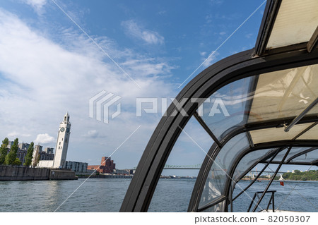 Montreal, Quebec, Canada - August 25 2021 : Clock Tower and St. Lawrence River from a boat. Montreal, Quebec, Canada - August 25 2021 : Clock Tower and St. Lawrence River from a boat. 82050307