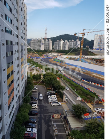 Construction. Development site. City. Building. Morning. Mountain. 82056847