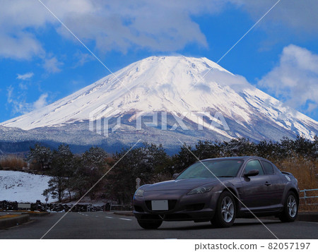 A photo of Mt. Fuji and a car with snow in the blue sky A photo of Mt. Fuji and a car with snow in the blue sky 82057197