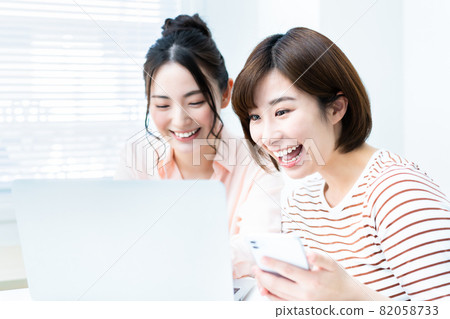 Two women making online reservations 82058733