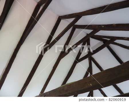 Fachwerk, a frame construction typical of the peasant architecture of many countries of Europe. Prussian wall. The roof truss system of the house. Ceiling beams, rafters and gratings. Fachwerk, a frame construction typical of the peasant architecture of many countries of Europe. Prussian wall. The roof truss system of the house. Ceiling beams, rafters and gratings. 82060919