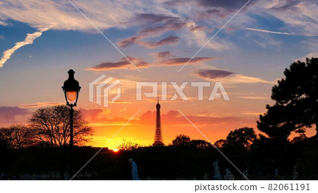 The setting sun over the city of Paris and the shadow of the towering Eiffel Tower The setting sun over the city of Paris and the shadow of the towering Eiffel Tower 82061191