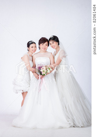 beautiful mother and cute daughters in white dress beautiful mother and cute daughters in white dress 82061484
