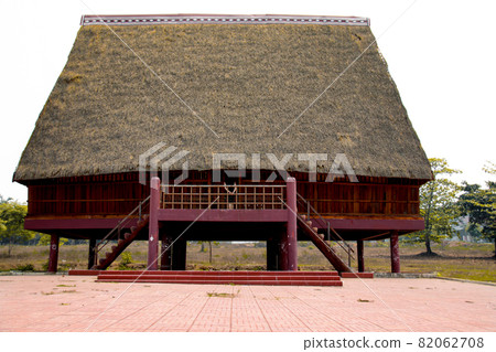 A tourist exploring a traditional architecture of a Bahnar ethnic stilt house or Rong House in Pleiku countryside, Vietnam A tourist exploring a traditional architecture of a Bahnar ethnic stilt house or Rong House in Pleiku countryside, Vietnam 82062708