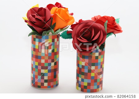 Handmade rose flowers made from origami are displayed in a beautiful vase Handmade rose flowers made from origami are displayed in a beautiful vase 82064158