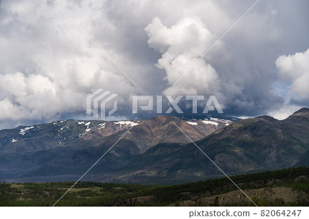 Inspirational mountain views. Thick gray clouds over the peaks. Inspirational mountain views. Thick gray clouds over the peaks. 82064247