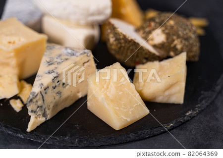 Cheese plate close up. Various types of flavored cheese. Cheese plate close up. Various types of flavored cheese. 82064369