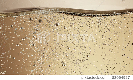 Close-up of champagne bubbles background with foam. 82064937