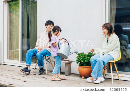 Girls and families relaxing in their garden Girls and families relaxing in their garden 82065535
