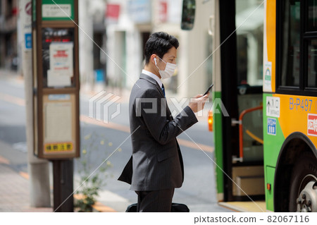 Businessman earphone bus stop bus Businessman earphone bus stop bus 82067116