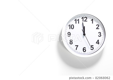 White clock face of a wall clock show the time. It's close to 12 o'clock. The latest report of the atomic scientist shows the doomsday clock 100 seconds to twelve. Concept design with black line 82068062