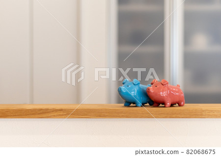 A piggy bank made of pottery placed on the counter of a newly built detached kitchen A piggy bank made of pottery placed on the counter of a newly built detached kitchen 82068675