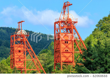 Two shaft hoisting machines towering over the Coal Mine Memorial Forest Park in Bibai City, Hokkaido [August] 82068688
