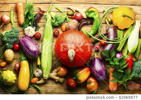 Raw vegetables on rustic wooden background Raw vegetables on rustic wooden background 82069877