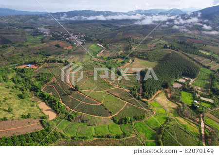 Aerial view landscape of Farm land fild in rural village mountains of asia with mist fog during morning time Aerial view landscape of Farm land fild in rural village mountains of asia with mist fog during morning time 82070149