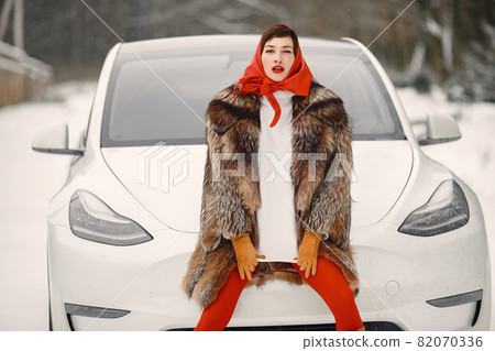 Elegant woman in a fur coat posing 82070336