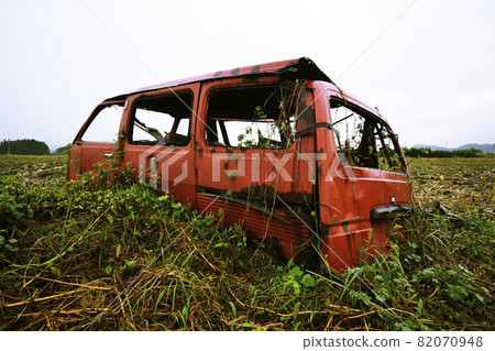 A decaying car next to a cornfield A decaying car next to a cornfield 82070948