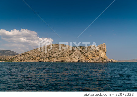 The Republic of Crimea. July 21, 2021. View of Mount Alchak, located near the city of Sudak, in sunny weather from the Black Sea. The Republic of Crimea. July 21, 2021. View of Mount Alchak, located near the city of Sudak, in sunny weather from the Black Sea. 82072328