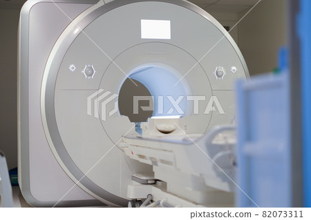 Modern magnetic resonance imaging machine standing in clinic background Modern magnetic resonance imaging machine standing in clinic background 82073311