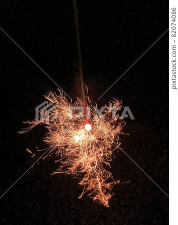 Sparkler with sparks Sparkler with sparks 82074086