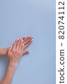 Perfect manicure gel art polish fashion design clean hand woman closeup on isolated background 82074112