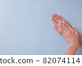 Beautiful woman pink manicure on creative blue background 82074114