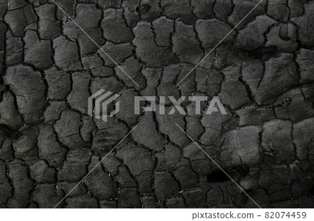 Natural fire ashes with dark grey black coals texture. It is a flammable black hard rock. Space for text. 82074459