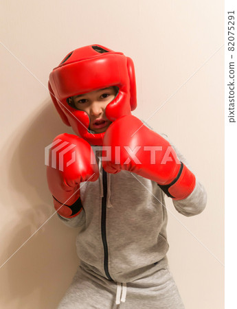 Portrait of young boxer on beige background Portrait of young boxer on beige background 82075291