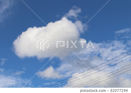 Electric wires, white fluffy round clouds, gray thin clouds and blue sky Electric wires, white fluffy round clouds, gray thin clouds and blue sky 82077294