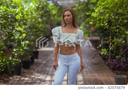 Smiling beauty in garden looking at camera. 82078879