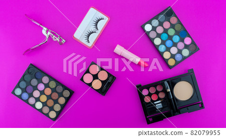 Multicolored beautiful eyeshadow palette and Various cosmetic accessories for makeup on pink background Beauty products Makeup cosmetic Summer eye shadow 82079955