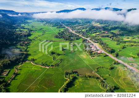 Aerial view landscape of Farm land fild in rural village mountains of asia with mist fog during morning time Aerial view landscape of Farm land fild in rural village mountains of asia with mist fog during morning time 82081224