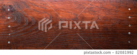 Background image of a dark brown horizontal board with old coarse wood grain 82081992