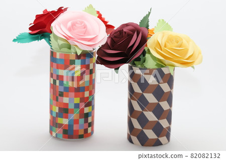 Handmade rose flowers made from origami are displayed in a beautiful vase Handmade rose flowers made from origami are displayed in a beautiful vase 82082132