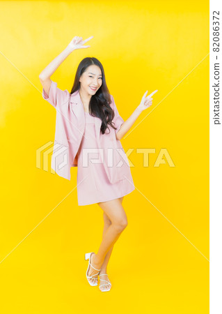 Portrait beautiful young asian woman smile with action Portrait beautiful young asian woman smile with action 82086372