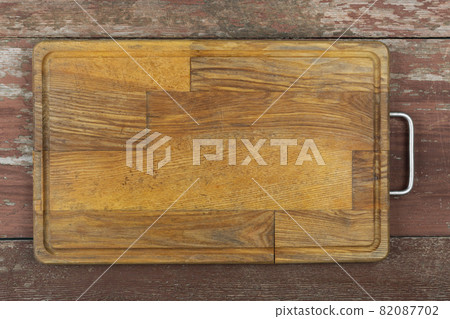 Empty cutting board on a wooden table. Space for text. 82087702