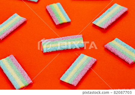 Licorice Candy. Sweet gummy sticks with different flavor, on red background. Licorice Candy. Sweet gummy sticks with different flavor, on red background. 82087703