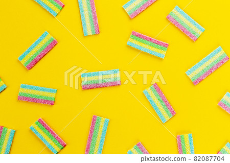 Licorice Candy. Sweet gummy sticks with different flavor, on yellow background. Licorice Candy. Sweet gummy sticks with different flavor, on yellow background. 82087704