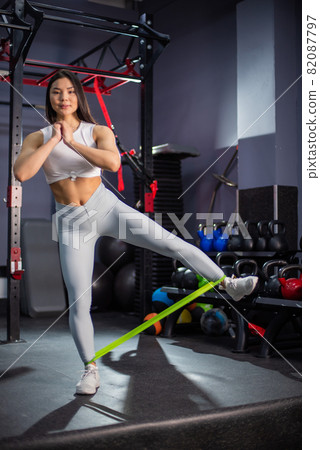 Asian woman doing exercise with fitness rubber band in the gym 82087797
