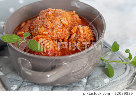 Meat balls on a light background with sage and parsley leaves. Homemade lunch. Meat balls on a light background with sage and parsley leaves. Homemade lunch. 82089889