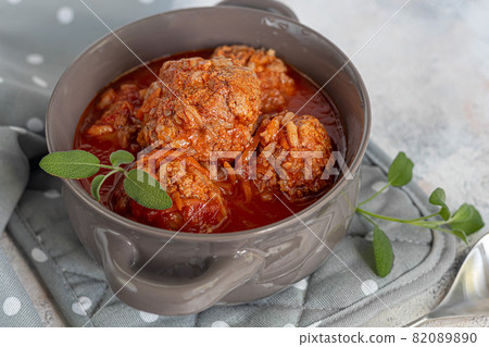 Meat balls on a light background with sage and parsley leaves. Homemade lunch. Meat balls on a light background with sage and parsley leaves. Homemade lunch. 82089890