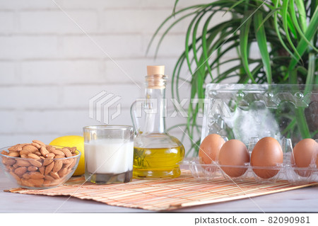 eggs in a plastic container, milk and almond nut in table  82090981