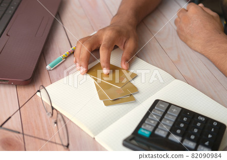 person hand holding credit card on table  82090984