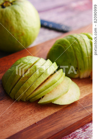 close up of slice of guava on a chopping board , close up of slice of guava on a chopping board , 82090999