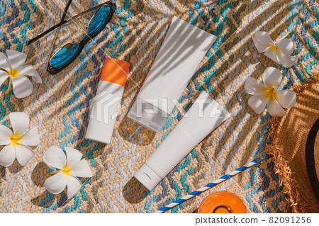 Lotion cream set near swimming pool. Face body care summer beauty treatment 82091256