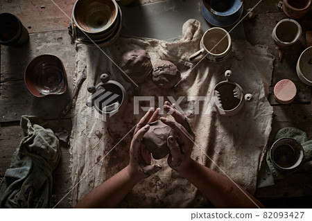 female  makes ceramic potter. 82093427